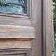 Oak entrance door and its frame and transom, wrought iron gates