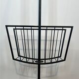 Designer floor lamp in black lacquered metal and brass, incorporating a magazine rack