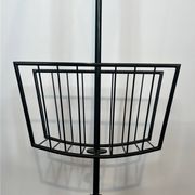 Designer floor lamp in black lacquered metal and brass, incorporating a magazine rack