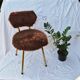 Vintage shaggy chair in faux fur with golden metal legs.