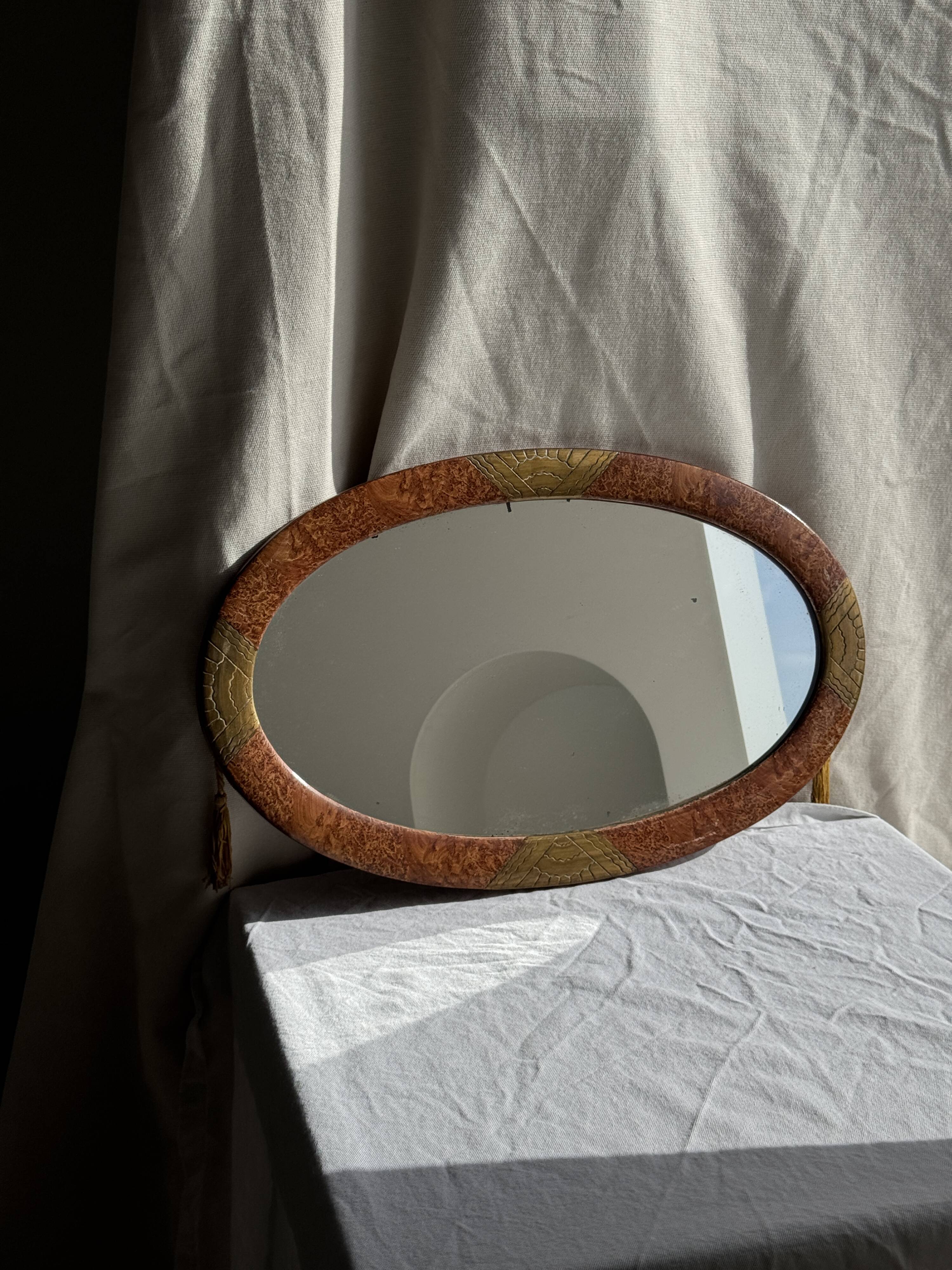 Small oval Art Deco mirror in brown and gold 33x54.