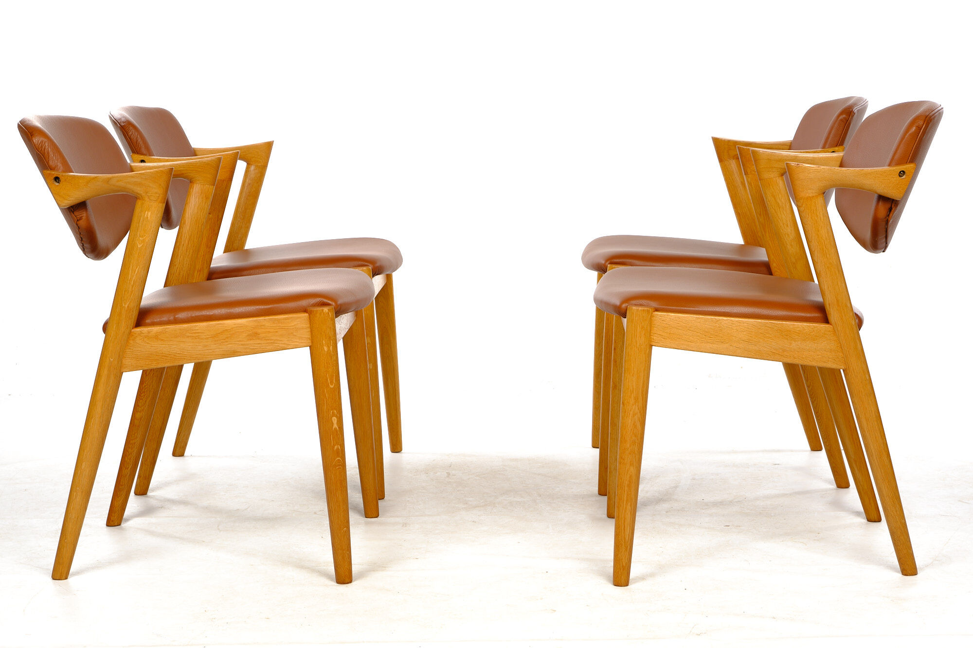 Four Kai Kristiansen oak chairs with new leather upholstery