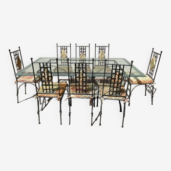 Iron garden table and glass top as well as 8 chairs