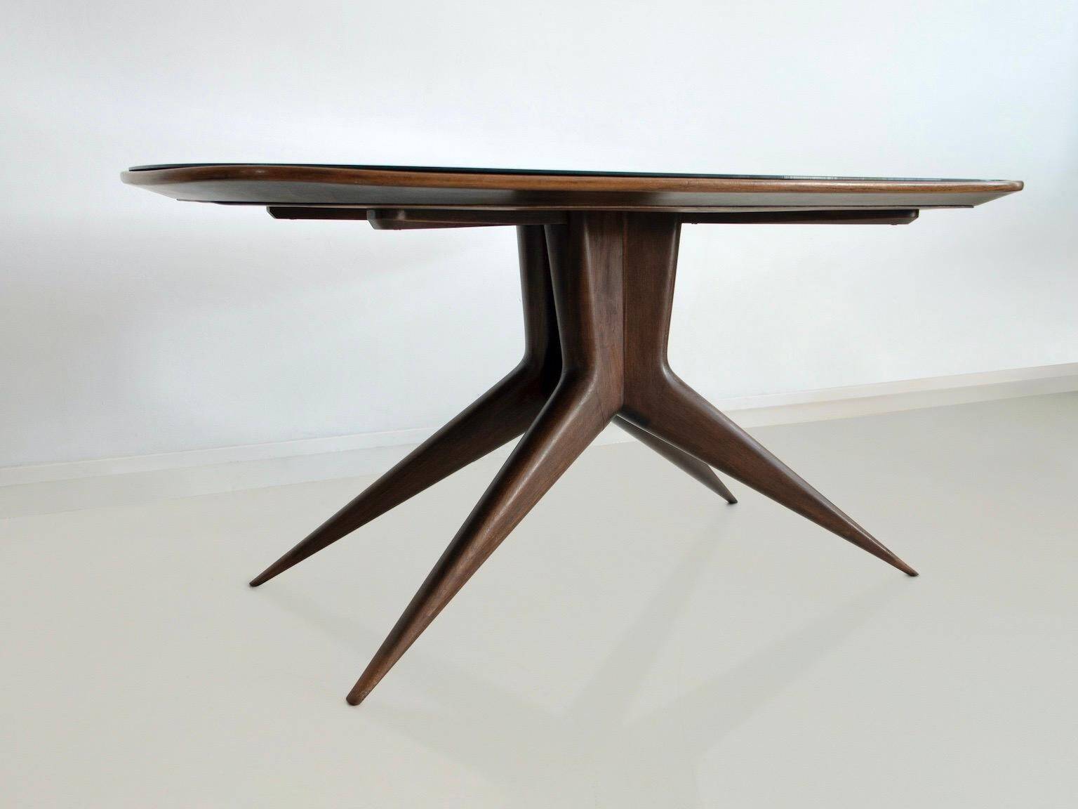 Dining table with a wooden frame and tinted glass top.