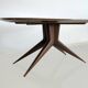 Dining table with a wooden frame and tinted glass top.