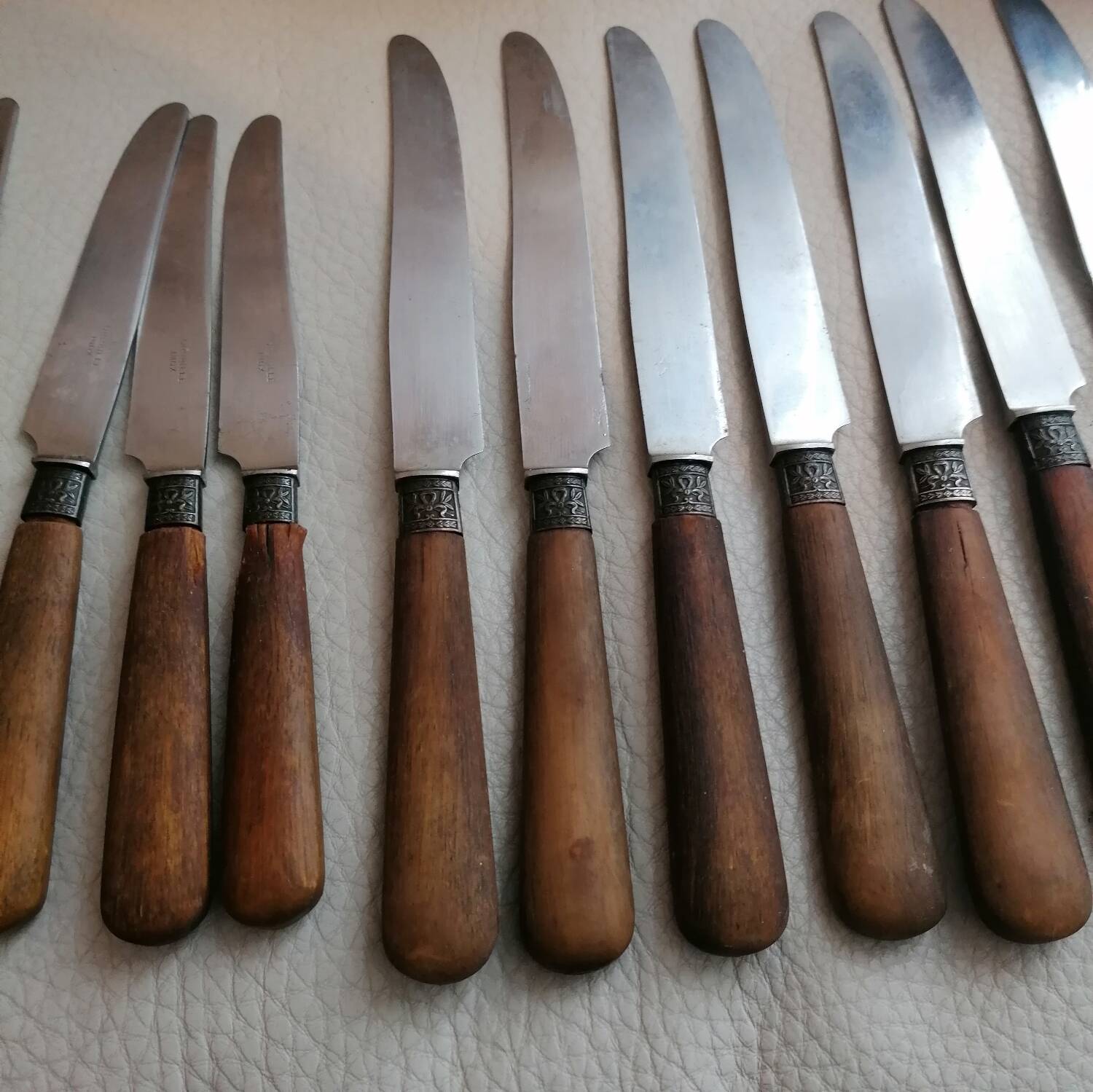Old table knives and dessert knives, wooden handles, stainless steel blades