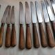 Old table knives and dessert knives, wooden handles, stainless steel blades