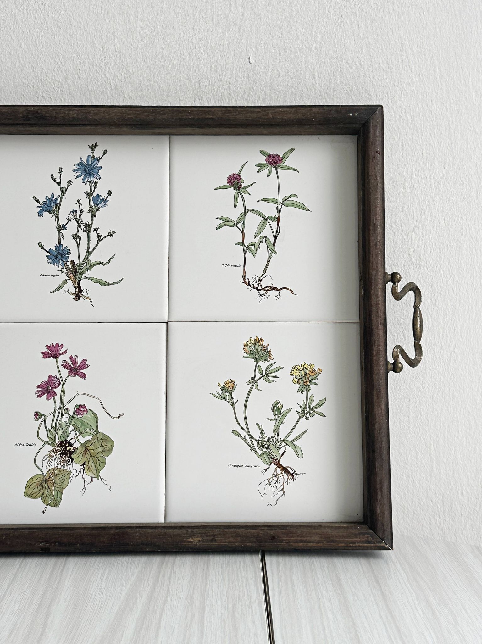 Old wooden plateau with floral tiles