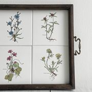 Old wooden plateau with floral tiles