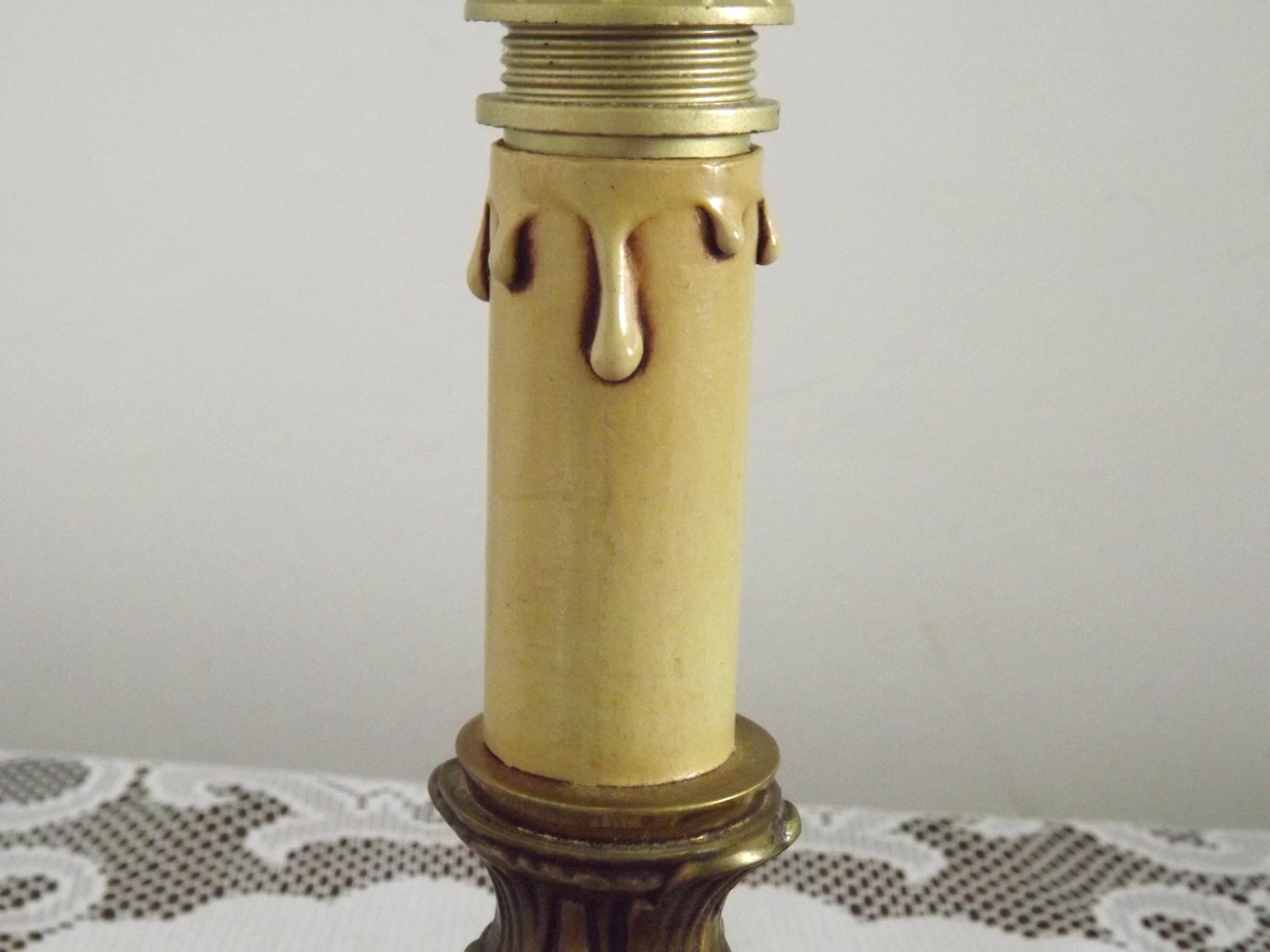 Vintage French bronze Wee Willie Winkie style lamp with red card shade.