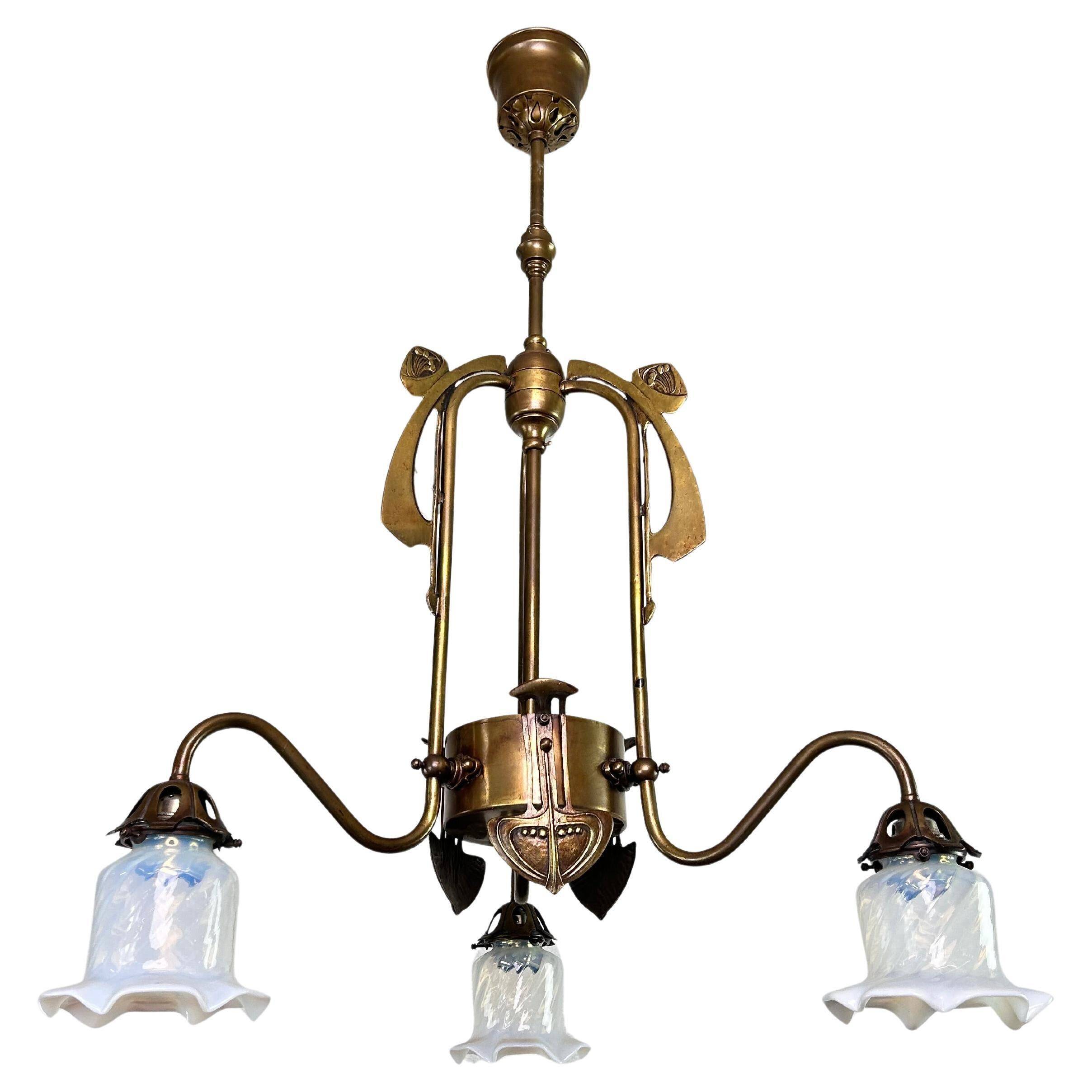 Art Nouveau chandelier with three arms and opalescent iridescent glass.