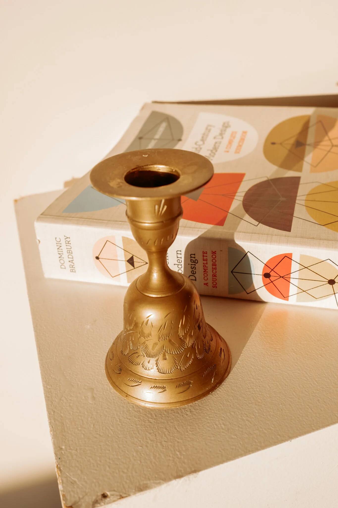 Brass candlestick in the shape of a bell.
