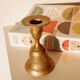 Brass candlestick in the shape of a bell.