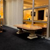 Table composed of a carved stone base with marble and hard stone inlay decoration