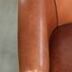 Sheepskin 2-seater sofa with a warm cognac brown colour scheme