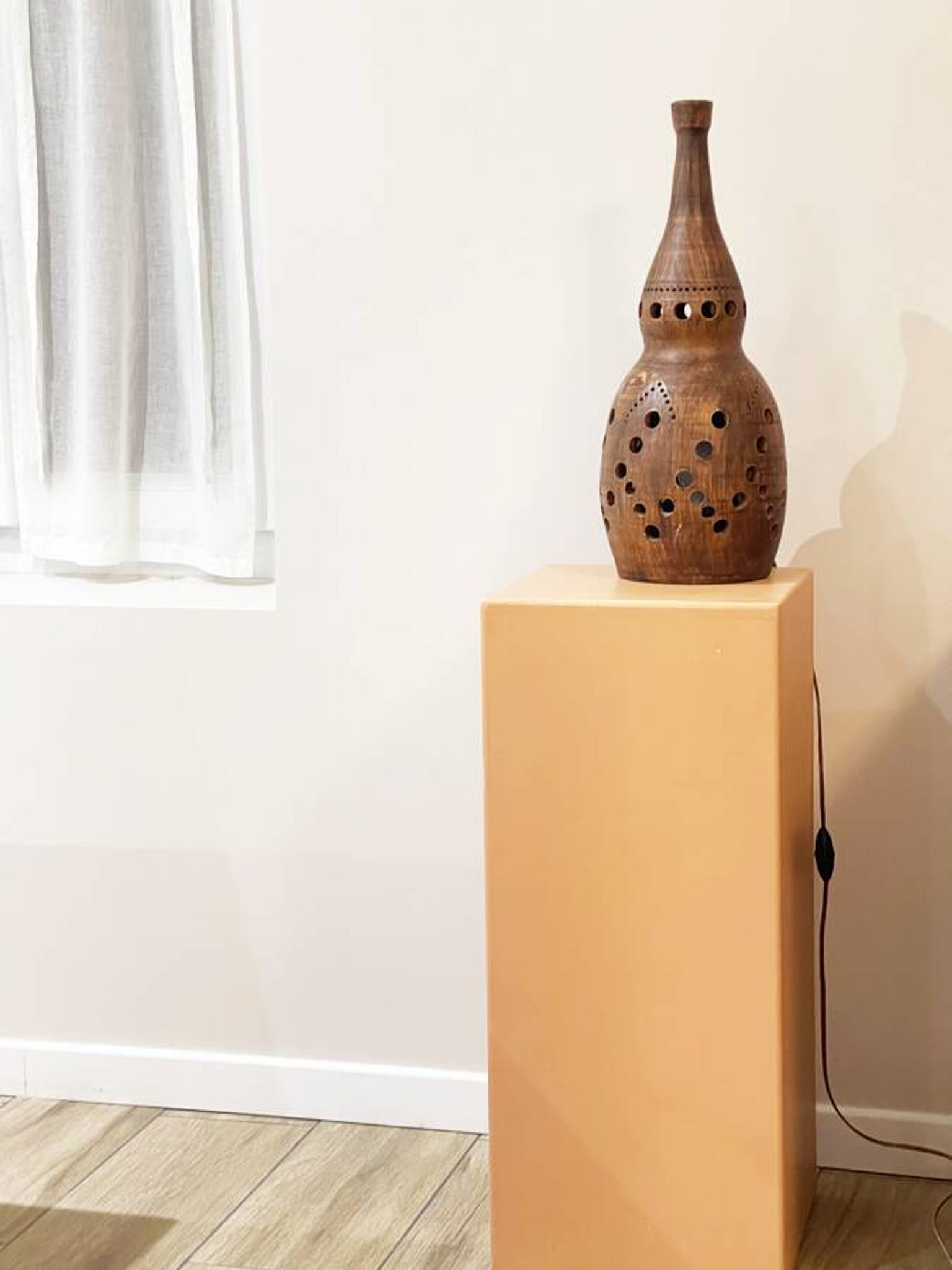 Terracotta lamp with cut-outs, circa 1970.