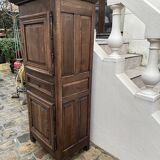 Man - standing - narrow two-door wardrobe with a central drawer