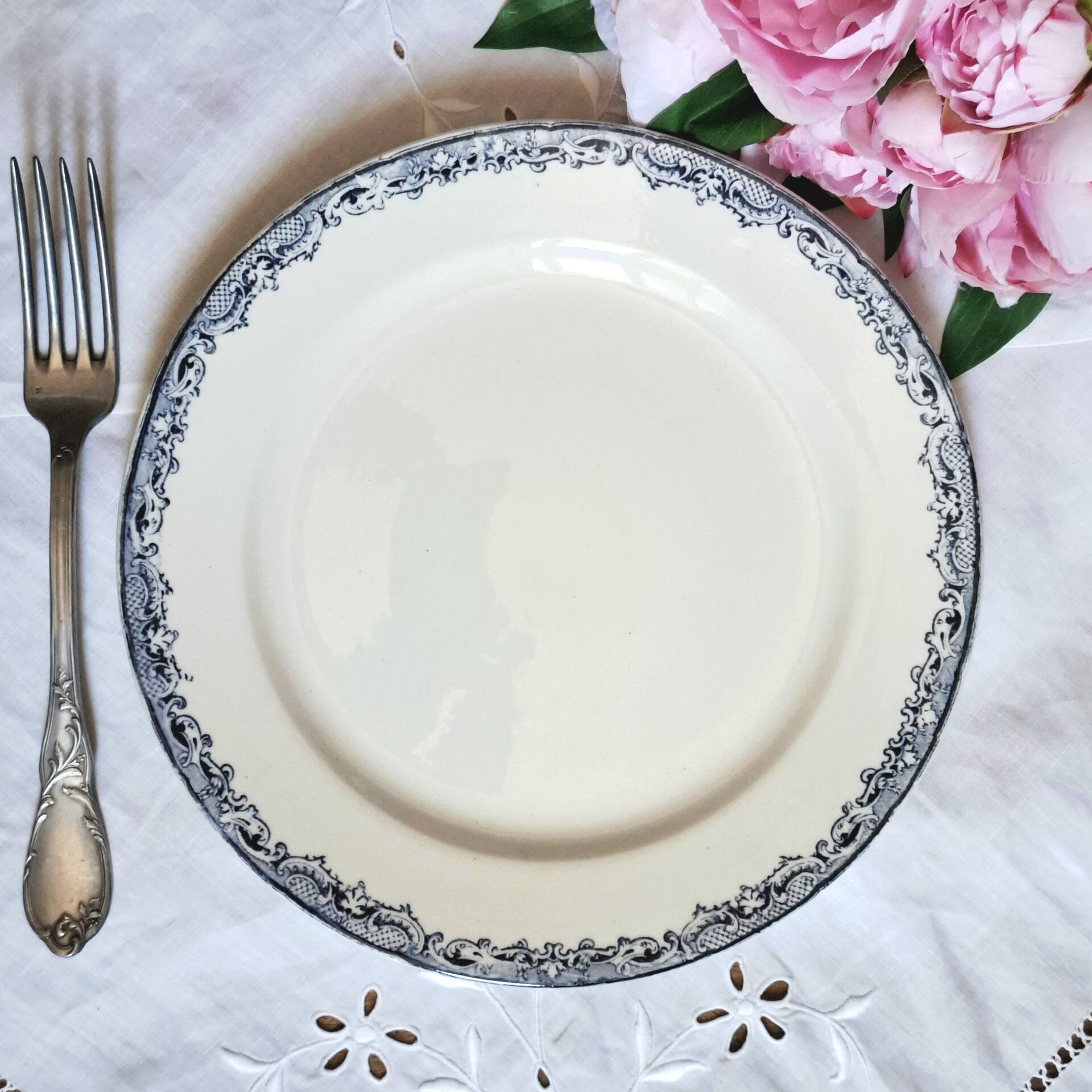 Old mismatched flat plates made of ironstone earthenware.