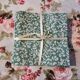 6 green cotton cloth napkins with white linens