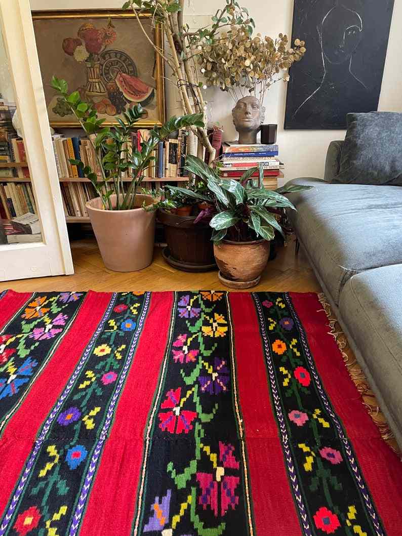 Romanian wool rug, red background with delicate colourful flowers