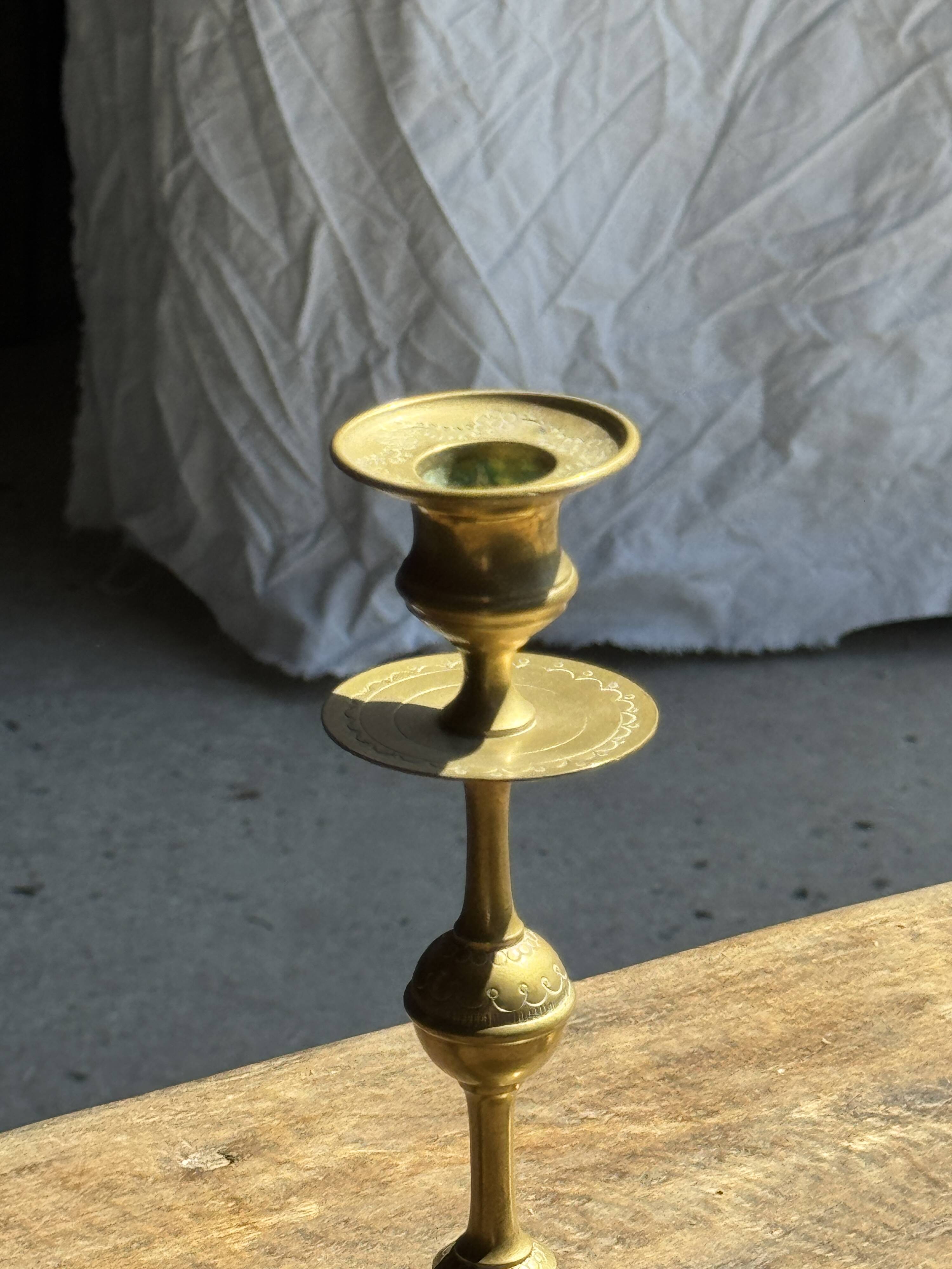 Pair of gilded candlesticks with engraved flower garland motifs H22