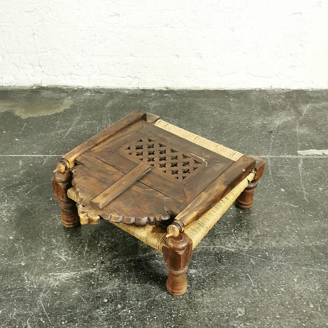 Ancient ethnic chair made of solid wood and rope