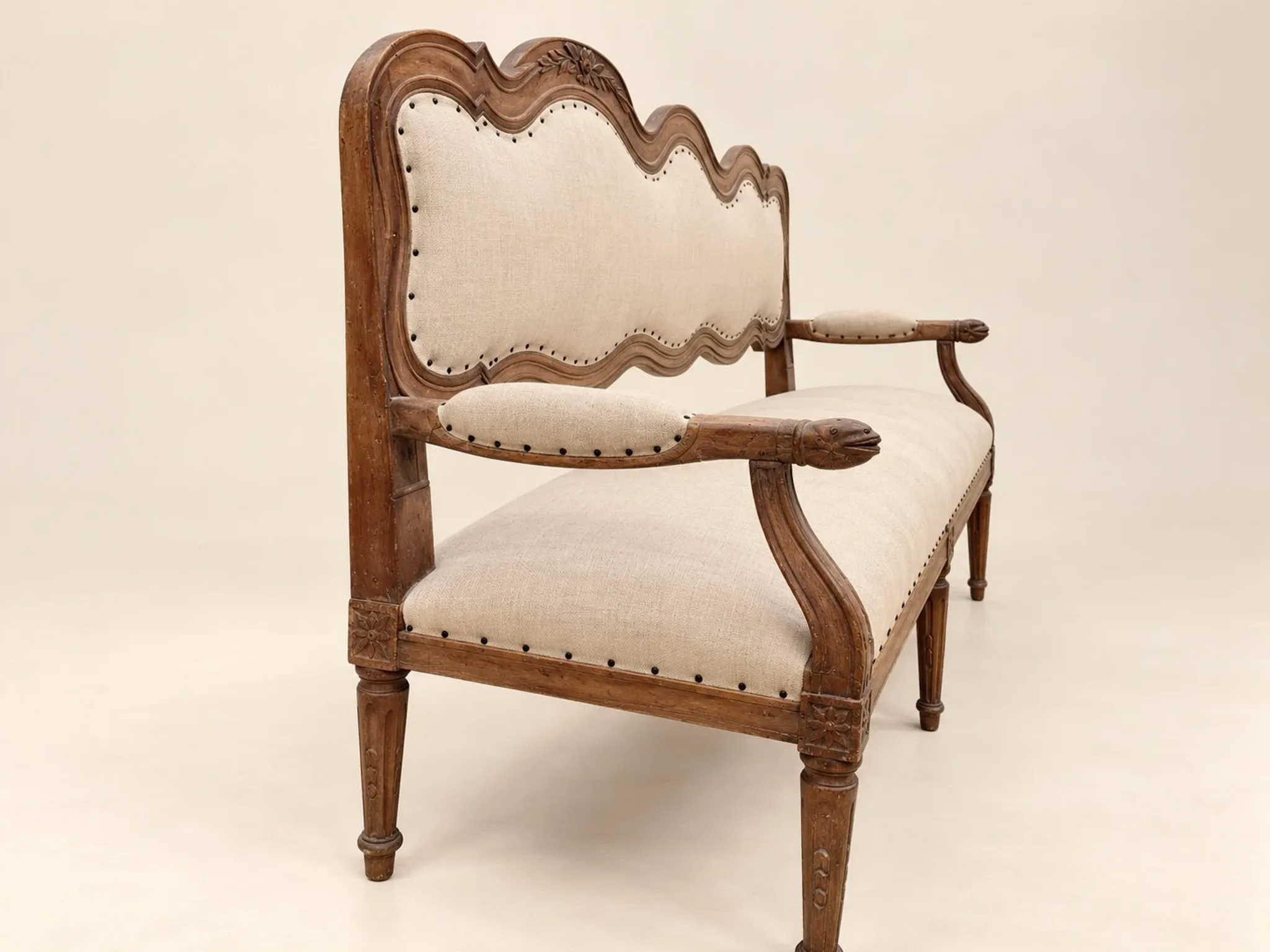 Louis XVI period canapé – Model with eel heads – Carved walnut