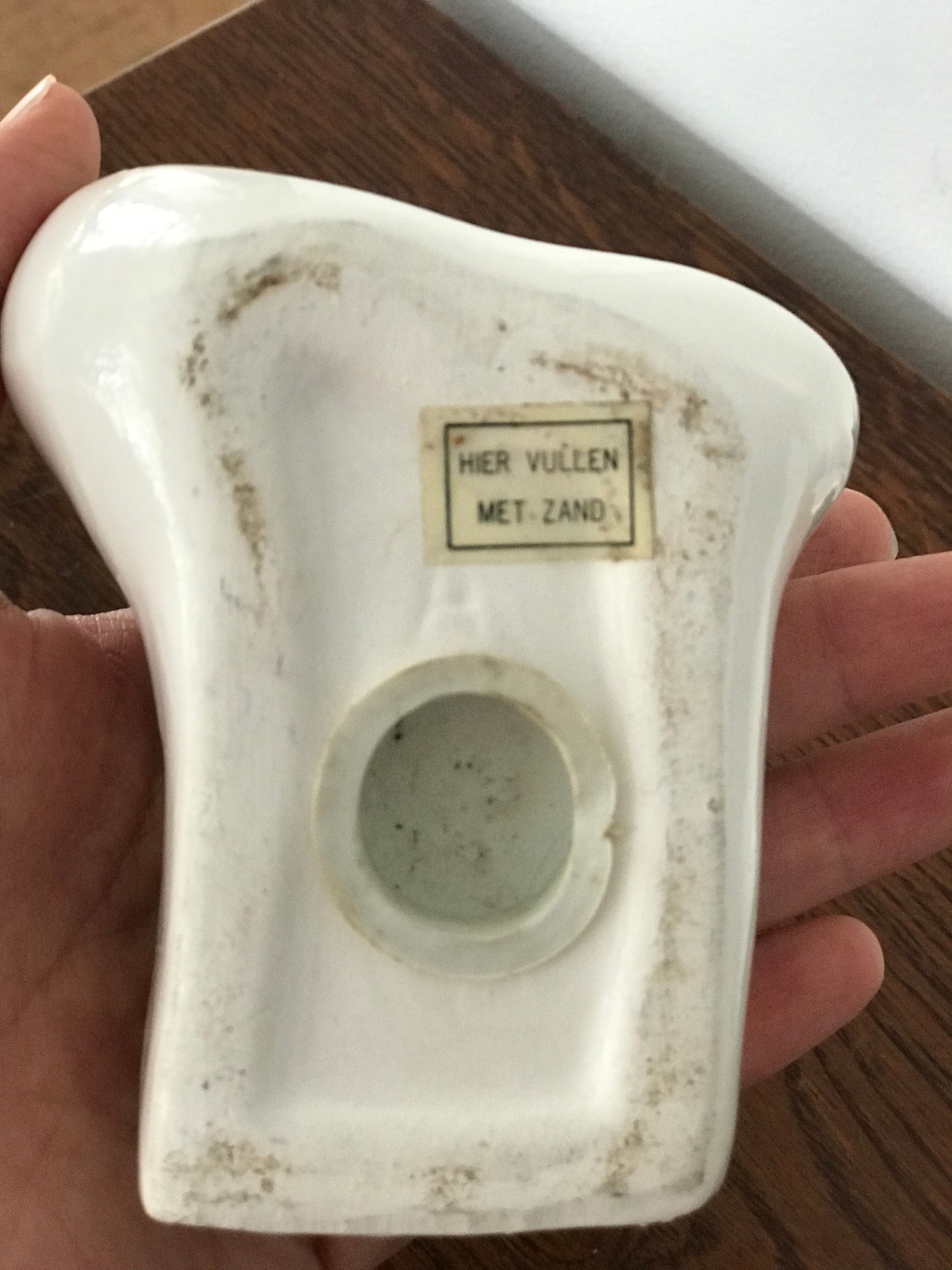 Hands tighten books in ceramics