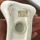 Hands tighten books in ceramics