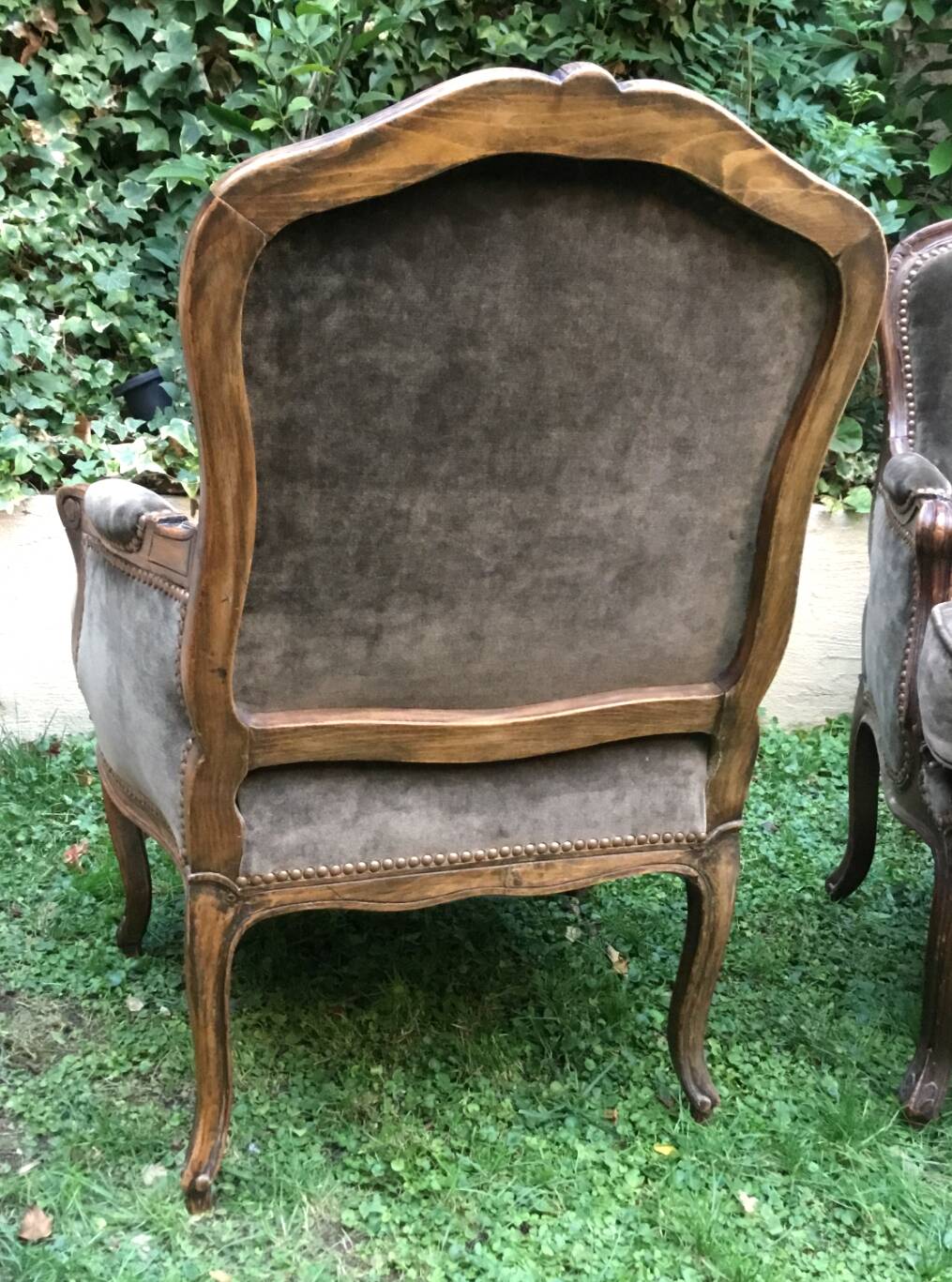 Pair of Louis XV style bergères in moulded and carved wood.