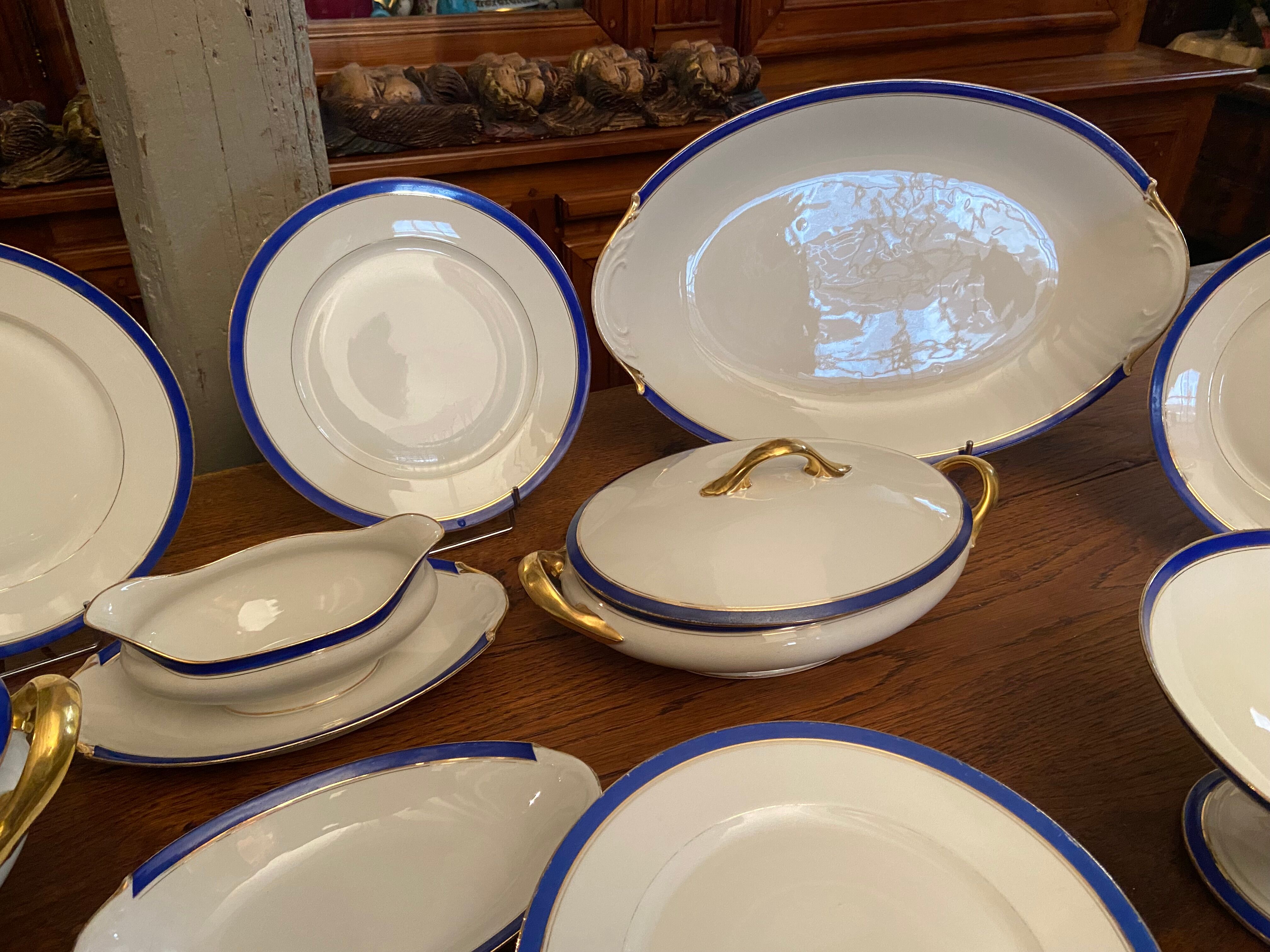 Service de table en porcelaine de Limoges à bandeau bleu sur fond blanc et or
