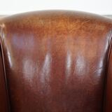 Sheepskin club armchair, correct finishing with decorative nails