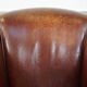 Sheepskin club armchair, correct finishing with decorative nails