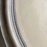 Beveled oval mirror in wood and stucco