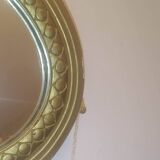 Oval mirror in wood and gilded plaster with pompom decoration