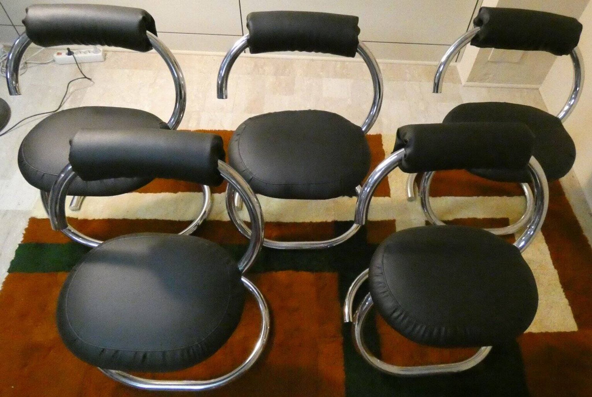 Cobra chairs in steel and black leather by Giotto Stoppino, 1970s, set of 5.