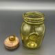 Yellow bubbled glass apothecary jar with cork lid.