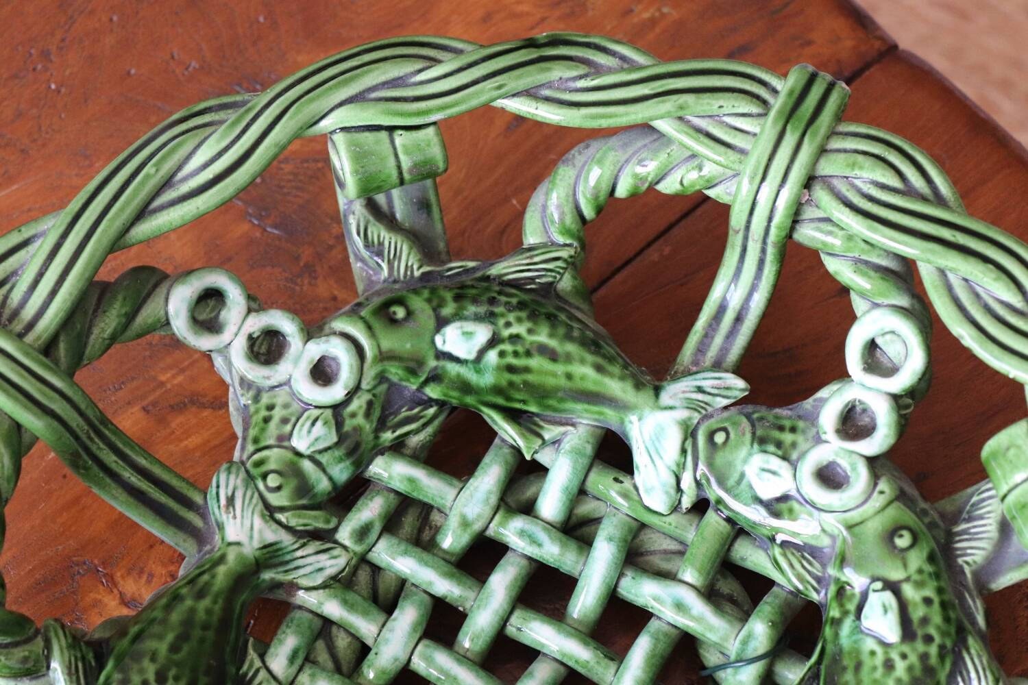 Antique woven basket in green glazed ceramic, fish decoration