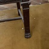 Antique carved wooden chairs with straw seats.