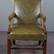 Elegant armchair and footrest in English green leather