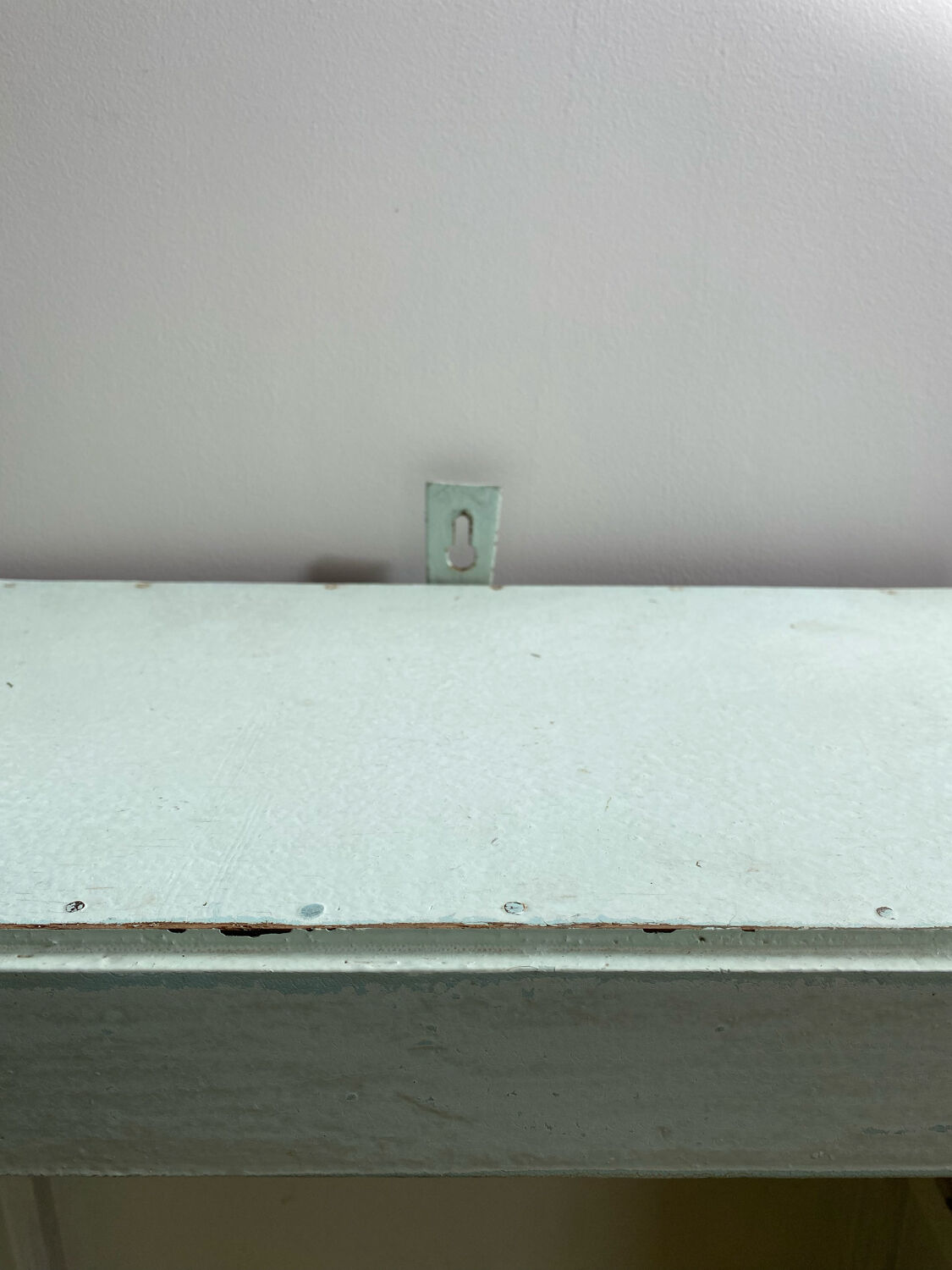 Old medicine cabinet in mint green patinated wood