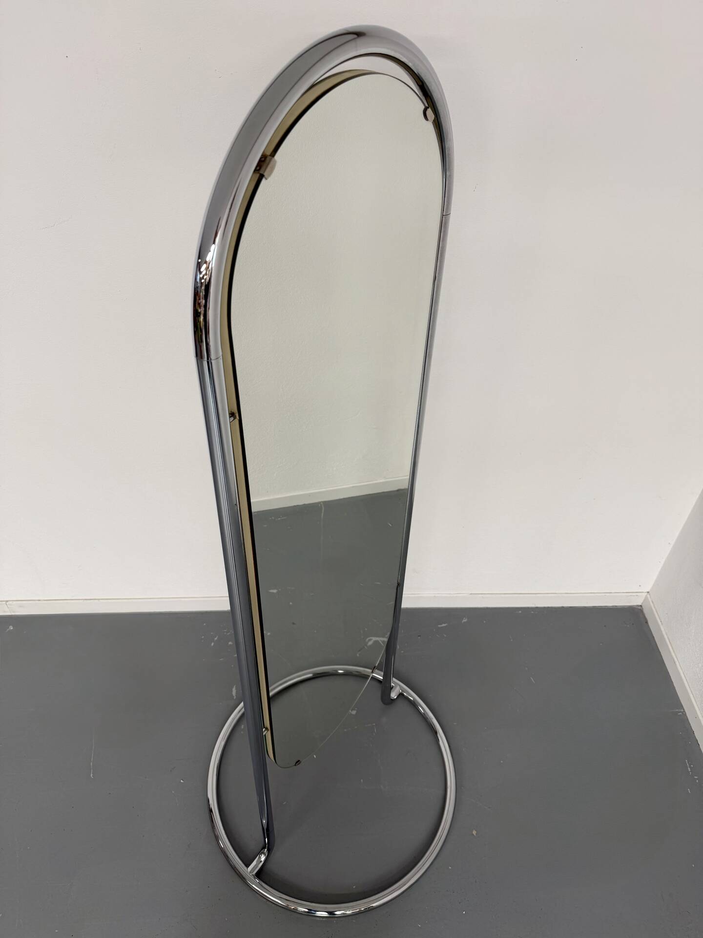 Large freestanding chrome metal full-length mirror in 1970s design.