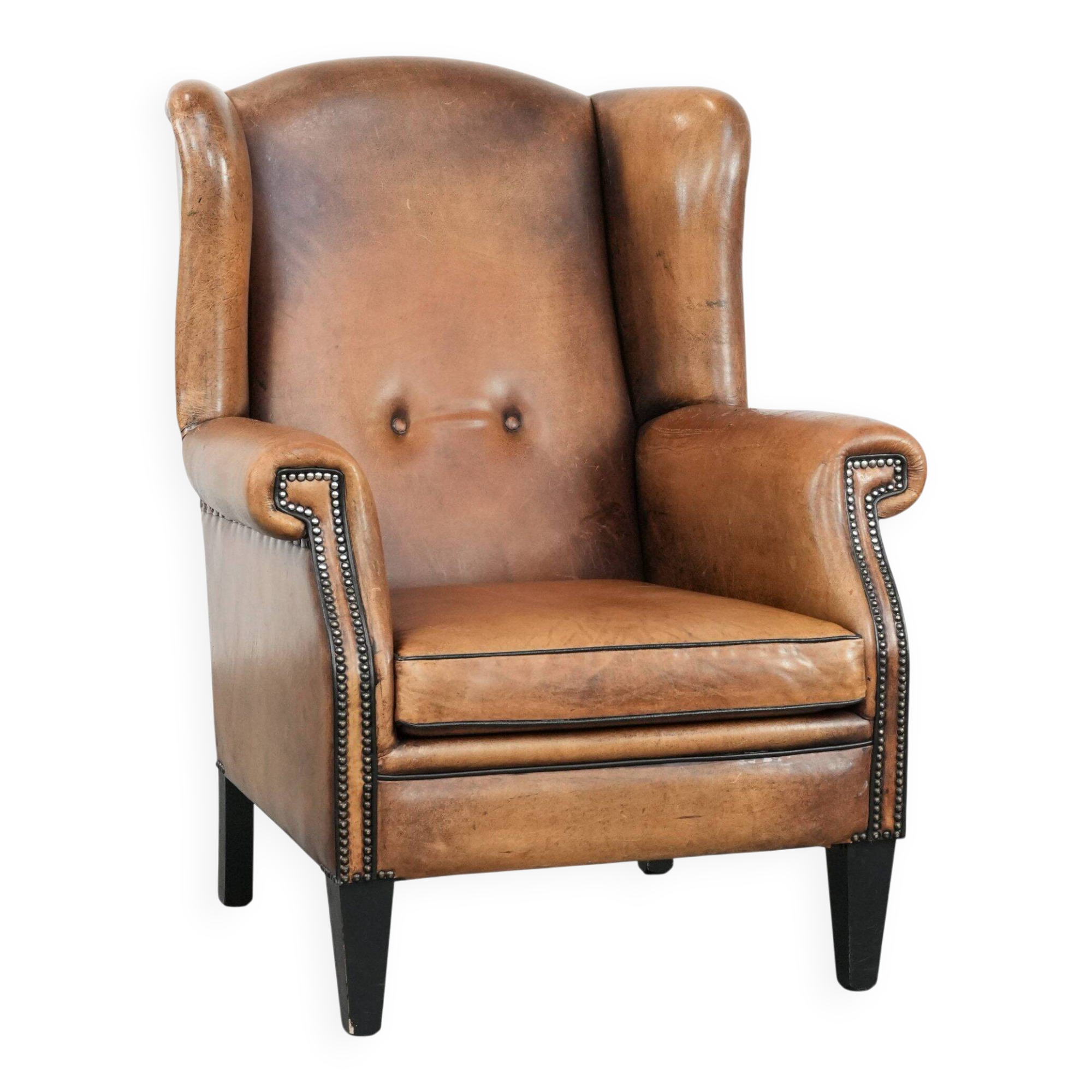 Large and comfortable sheepskin leather wingback chair with black piping