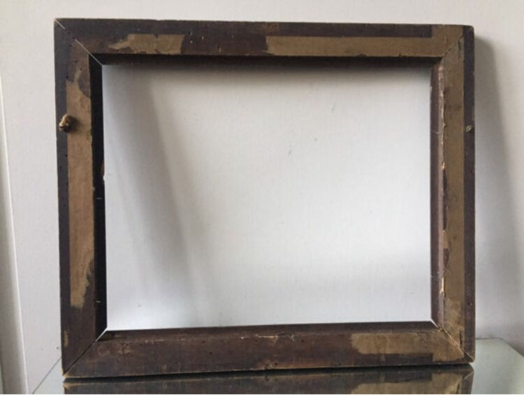 Antique wooden frame with geometric carvings light distress