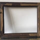Antique wooden frame with geometric carvings light distress