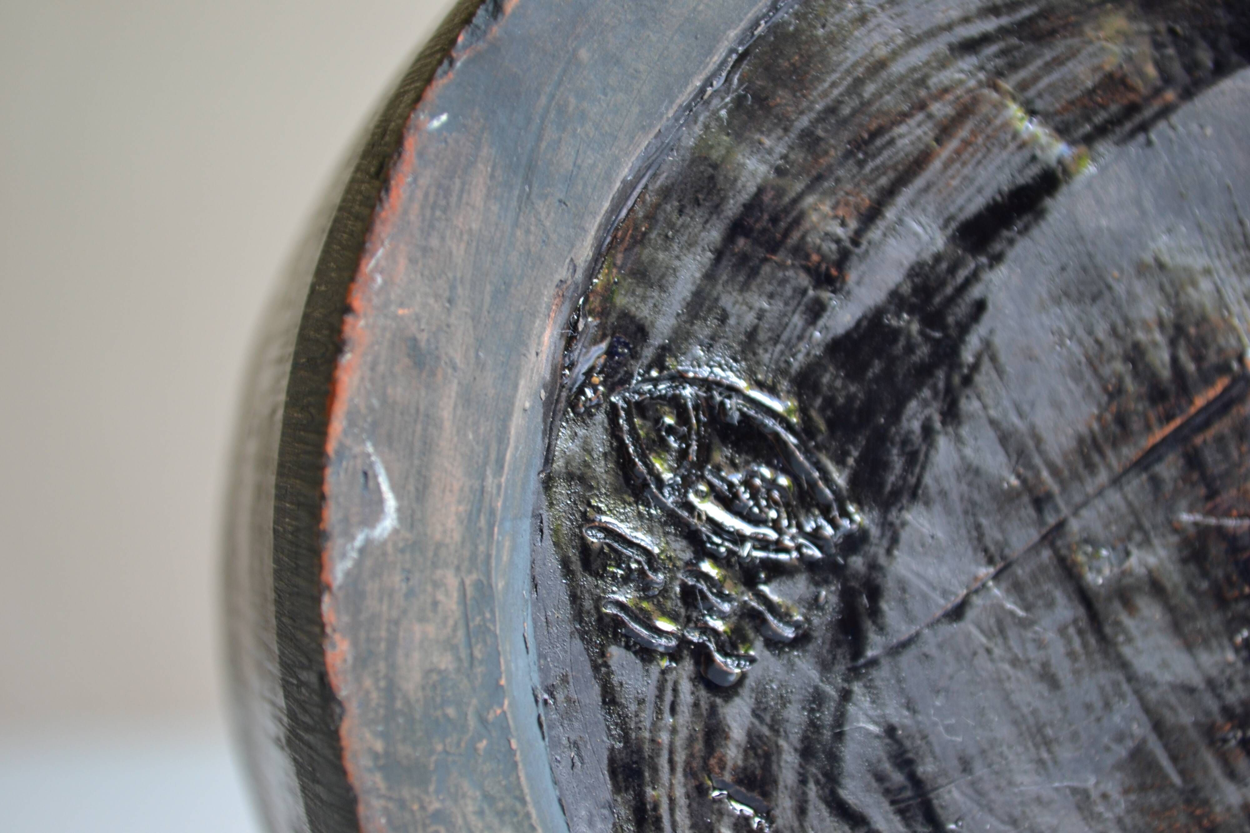 Ceramic vase with a signature fish to identify.