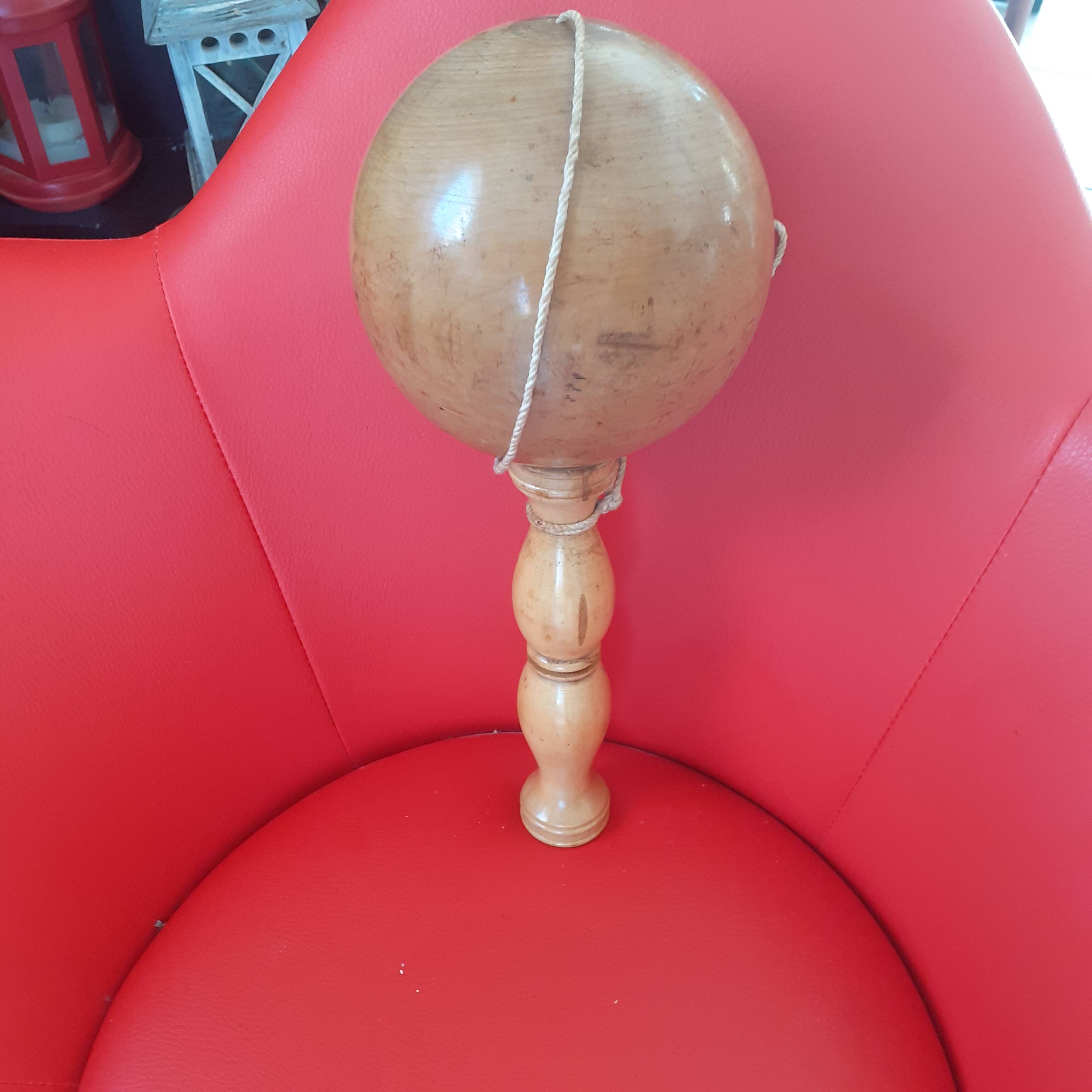 Large cup-and-ball cup in light wood.