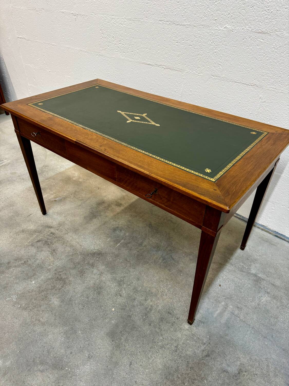 Louis XVI desk with green leather and shelves.