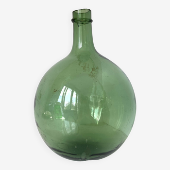 Old demijohn in green glass with ringed neck and hammered opening