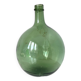 Old demijohn in green glass with ringed neck and hammered opening